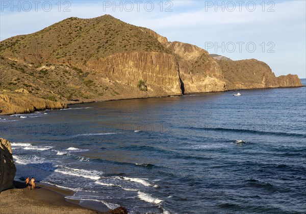 Man and woman holding hands walking on beach, Isleta del Moro, Cabo de Gata natural park, Almeria, Spain, Europe