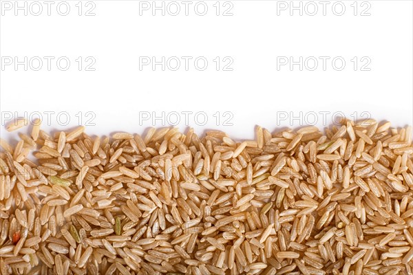 Texture of brown rice isolated on white background. Top view. Copy space