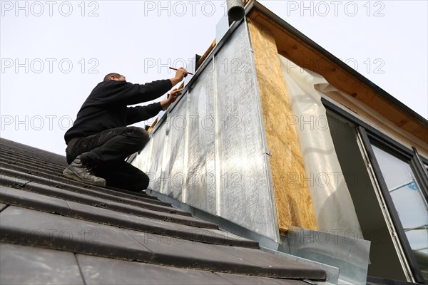 Roofer working on a new dormer window (model relased)