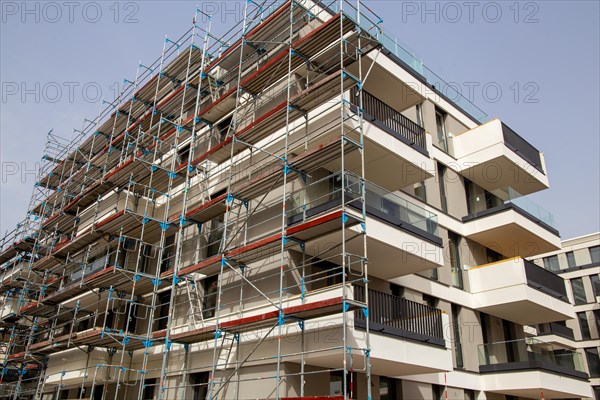 Painter painting the facade of a new apartment building