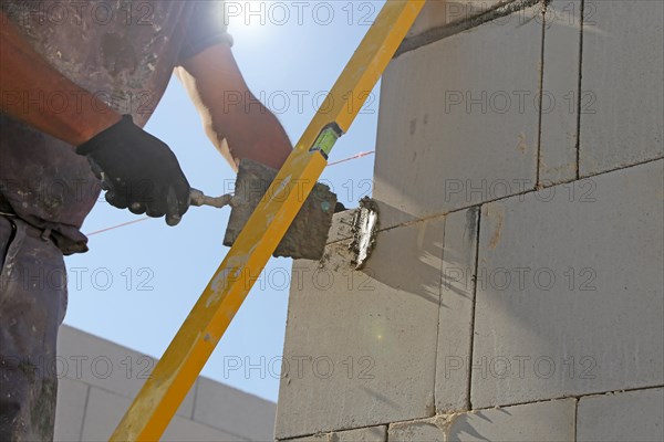 Construction worker (bricklayer) on the building site