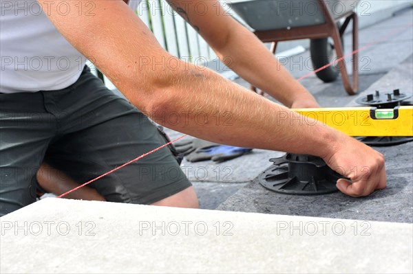 Worker lays paving stones