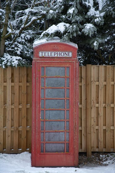 UK red telephone box covered in snow on a winter day, Suffolk, England, United Kingdom, Europe