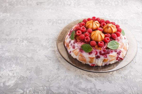Homemade jelly cake with milk, cookies and raspberry on a gray concrete background. side view, copy space