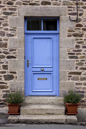 House facade with blue entrance door and two flower pots on steps, Pontrieux, Departement Cotes dArmor, Brittany, France, Europe