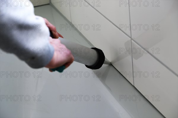 Grouting work. Tiler grouting in a new bathroom