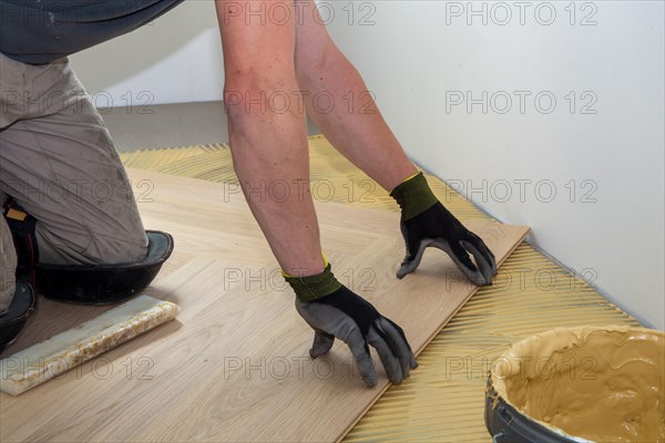 Craftsmen laying herringbone parquet professionally