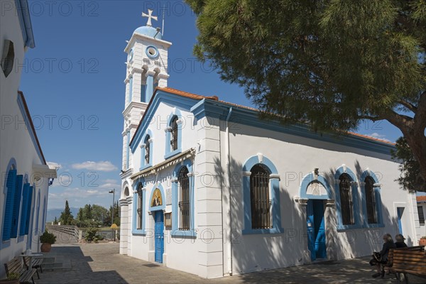 Church on a sunny day, people sitting on park benches in the shade, Monastery of St Nicholas, Monastery of Agios Nikolaos, Agiou Nikolaou, Vistonidas Burma Lagoon, Porto Lagos, Xanthi, Eastern Macedonia and Thrace, Greece, Europe