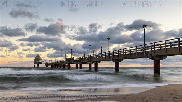 Sunrise at the pier of zingst during an icy storm as a long exposure