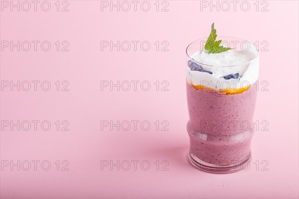 Smoothie with honeysuckle, linen and chia in a glass on pink pastel background. side view, close up, copy space