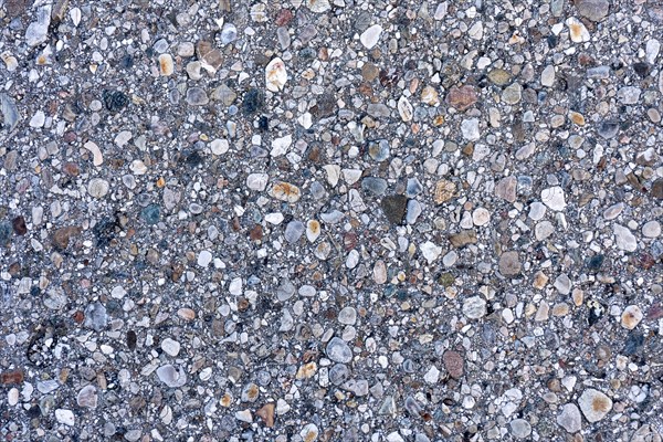 Asphalt road surface, enclosed colourful stones, grainy, pattern, structure, background, wallpaper