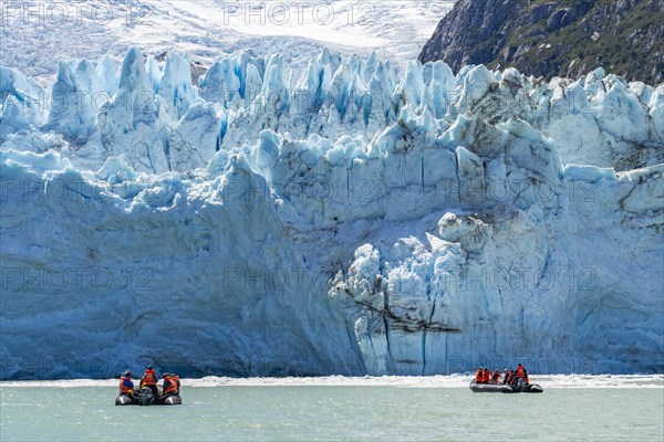 Passengers of the cruise ship Stella Australis in rubber dinghies in front of the ice of the Porter Glacier, Alberto de Agostini National Park, Avenue of the Glaciers, Chilean Arctic, Patagonia, Chile, South America