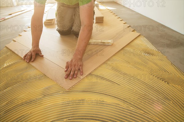 Craftsmen laying herringbone parquet professionally