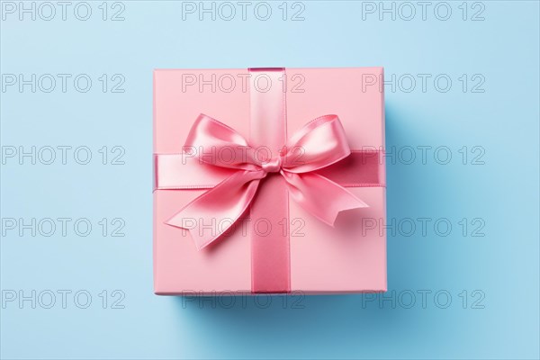 Top view of pink gift box on blue background. KI generiert, generiert AI generated
