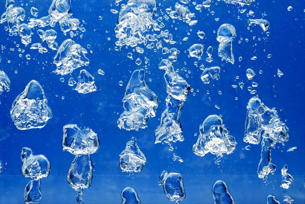 Bright Air bubbles, blue background in an aquarium