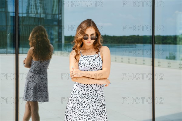 Portrait of offended woman with pouted lips in urban background