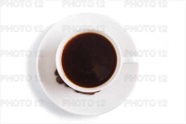 A cup of coffee with coffee beans on a plate, isolated on white, top view, closeup