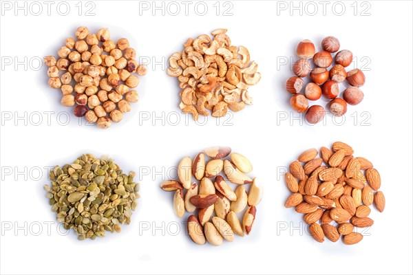 Piles of various nuts and seeds isolated on white background. hazelnut, brazil nut, almond, pumpkin seeds, cashew. top view