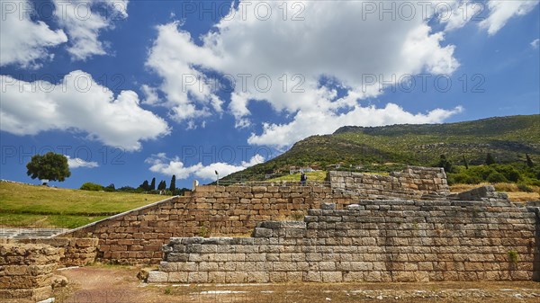 Ruins of an ancient wall in front of a light blue sky with fleecy clouds, Archaeological site, Ancient Messene, capital of Messinia, Messini, Peloponnese, Greece, Europe