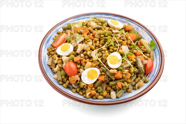 Mung bean porridge with quail eggs, tomatoes and microgreen sprouts isolated on a white background. Side view, close up