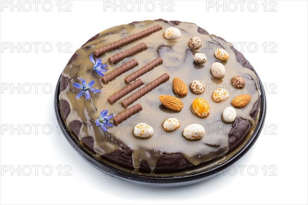 Homemade chocolate brownie cake with caramel cream and almonds isolated on a white background. Side view, close up
