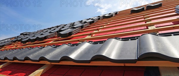 Panoramic image of the roof covering of a new tiled roof on a residential building