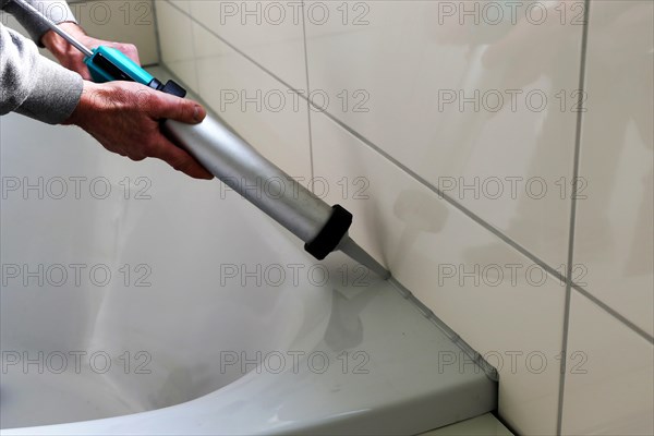 Grouting work. Tiler grouting in a new bathroom