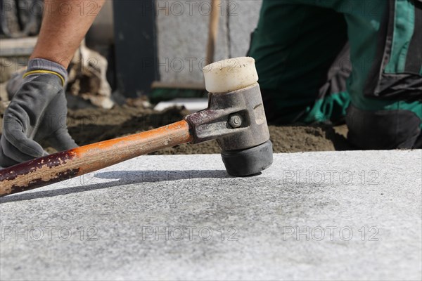 Worker lays paving stones