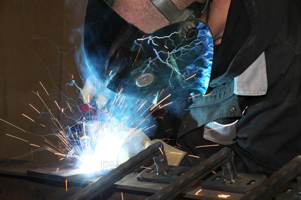 Metalworker during welding work in his workshop