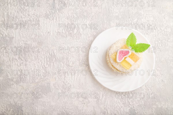 Decorated cake with milk and coconut cream on a gray concrete background. top view, flat lay, copy space