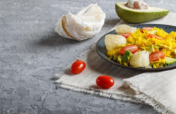 Fried pomelo with tomatoes and avocado on gray concrete background. side view, close up, copy space, myanmar food