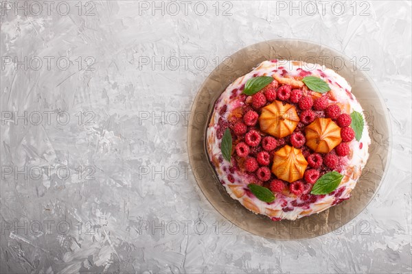 Homemade jelly cake with milk, cookies and raspberry on a gray concrete background. top view. flat lay, copy space