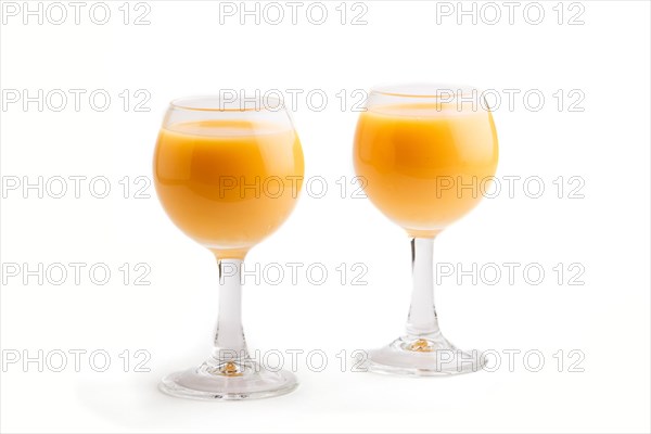 Sweet egg liqueur in glass isolated on white background. Side view, close up