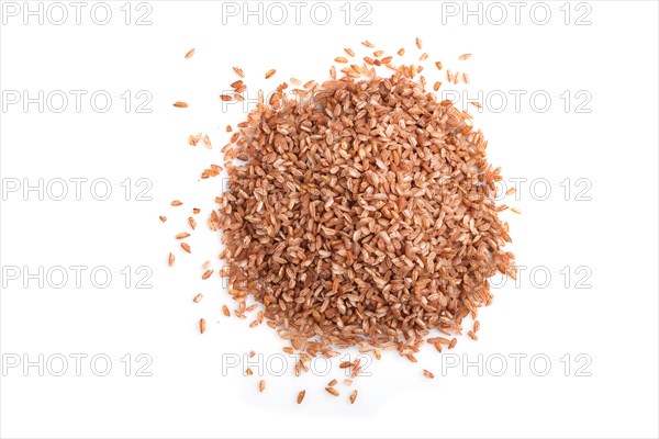 Heap of unpolished brown rice isolated on white background. Top view, flat lay, close up, macro