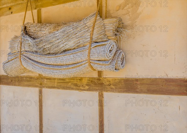 Traditional Korean sleeping mats hanging in rope on exterior wall in South Korea