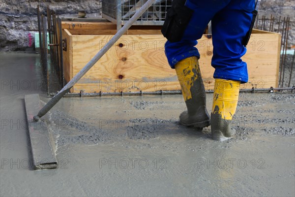 Concreting a floor slab with ready-mixed concrete on the construction site of a residential building