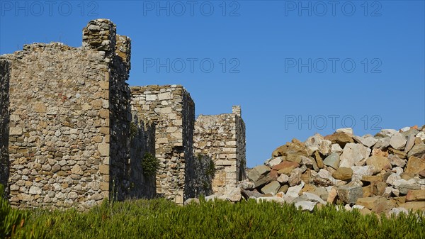 Remnants of ancient walls towering against a clear blue sky, Methoni sea fortress, Peloponnese, Greece, Europe