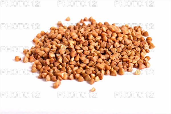 Pile of buckwheat isolated on white background. Closeup