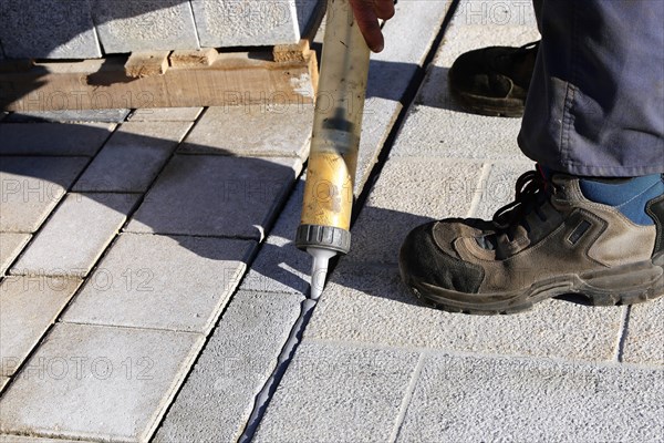 Worker lays paving stones