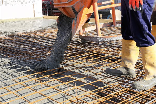 Concreting a floor slab with ready-mixed concrete on the construction site of a residential building