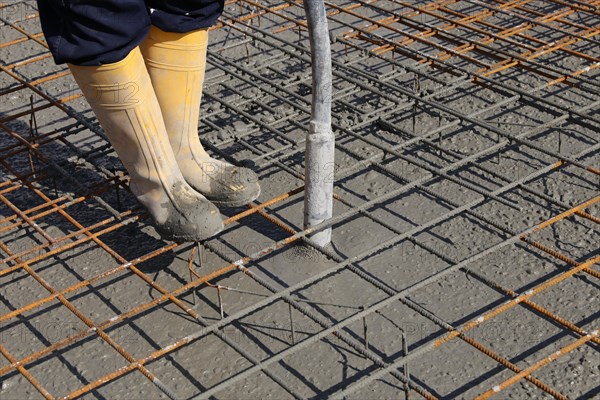 Concreting a floor slab with ready-mixed concrete on the construction site of a residential building