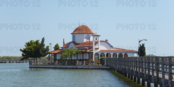 Small church with tiled roof on the water's edge with connection via a bridge, Monastery of St Nicholas, Monastery of Agios Nikolaos, Agiou Nikolaou, Vistonidas Burma Lagoon, Porto Lagos, Xanthi, Eastern Macedonia and Thrace, Greece, Europe