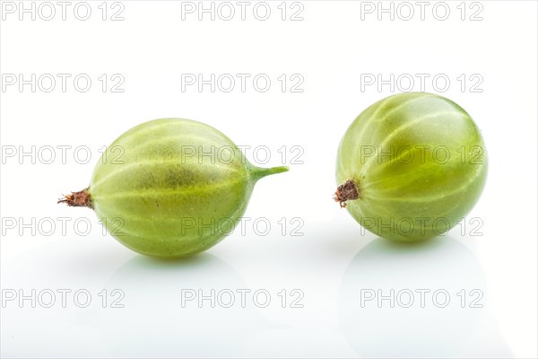 Two ripe green gooseberries isolated on white background. side view, close up