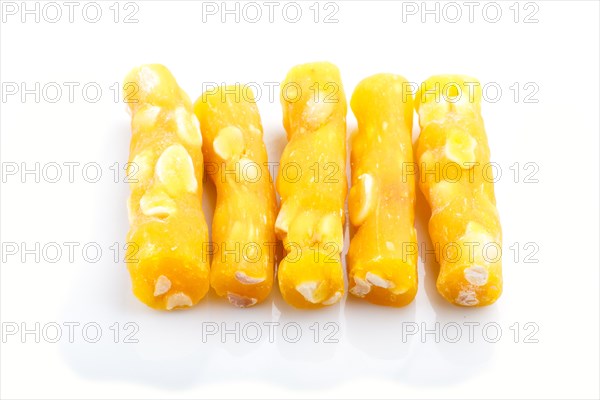 Yellow traditional turkish delight (rahat lokum) with peanuts isolated on white background. side view, close up