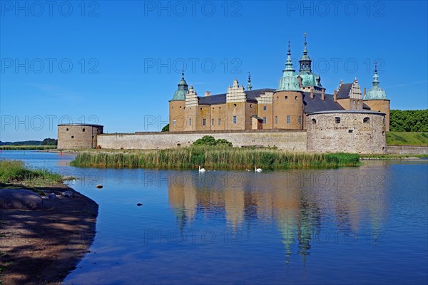 A historic castle surrounded by water under a blue sky with clouds, Kalmar, Sweden, Europe