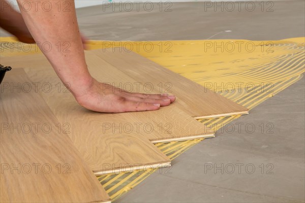 Craftsmen laying herringbone parquet professionally