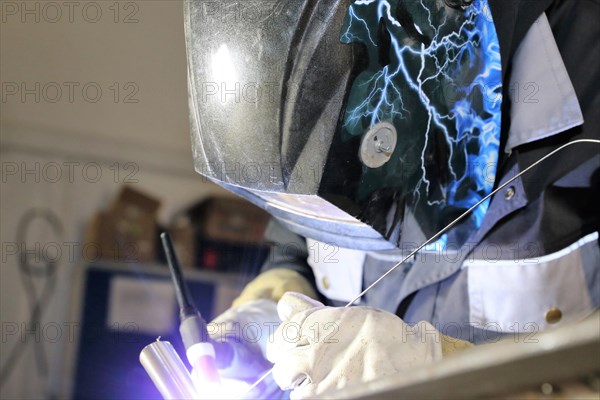 Metalworker during welding work in his workshop