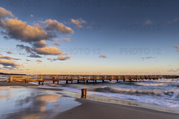 Sunrise at the pier of zingst during an icy storm as a long exposure