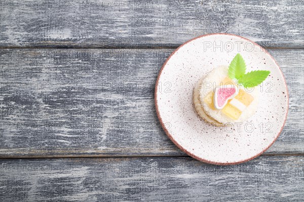 Decorated cake with milk and coconut cream on a gray wooden background. top view, flat lay, copy space