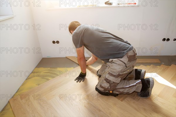 Craftsmen laying herringbone parquet professionally